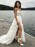 Woman in a white wedding dress standing by a lake