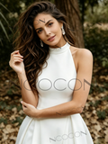 Woman in a white dress with 'Ncocon' branding in a natural setting
