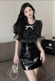 Stylish Black Sequin Top with Bow Detail and Leather Skirt