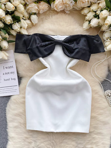 Elegant White Dress with Bold Black Bow