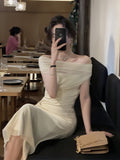 Ivory Elegance Off-Shoulder Pleated Midi Dress