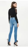 CROSSED STRAPS FOOT SLIM JEANS