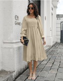 Long-sleeved pleated dress with flared sleeves and long neck