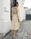 Long-sleeved pleated dress with flared sleeves and long neck